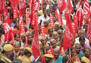  Construction workers attached to AITUC blocking the road near Ramanathapuram in Coimbatore seeking fulfillment of various demands on Tuesday. (The Hindu, July 22, 2015